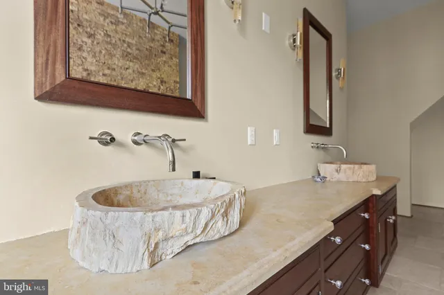 a bathroom with a tub sink and mirror