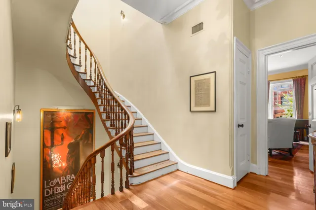 a view of entryway and hall with wooden floor