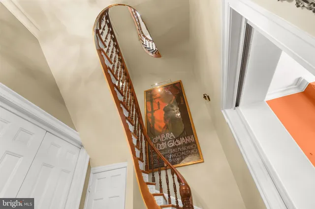 a view of staircase with white walls and a window