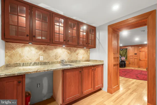 a kitchen with granite countertop wooden cabinets a sink and dishwasher