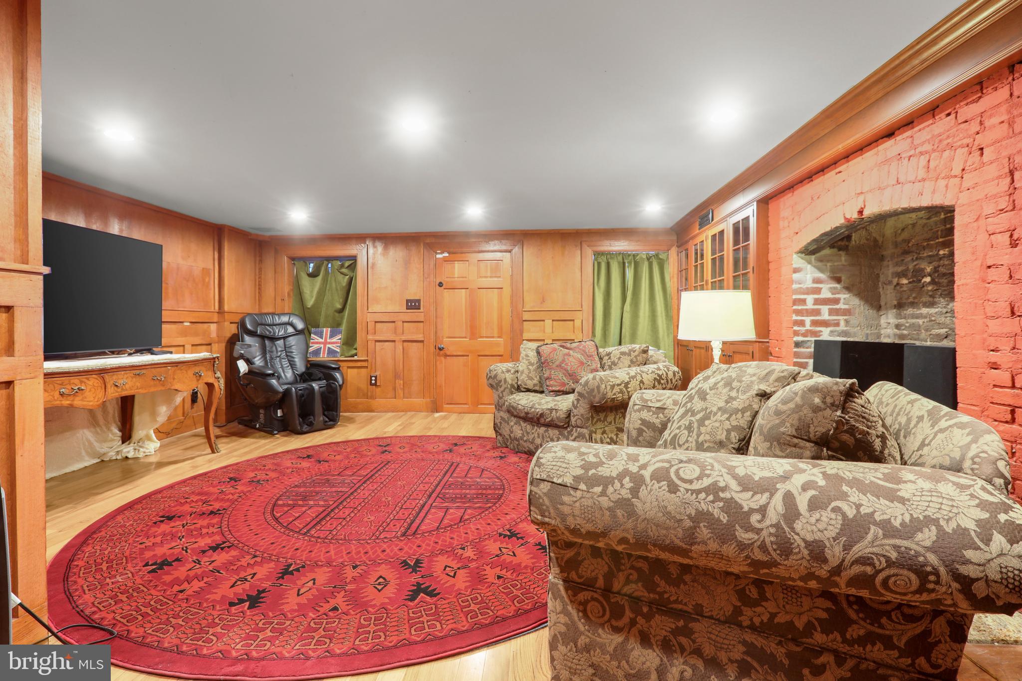 1007 North Calvert Street Baltimore, MD 21202 - Photo 37 of 43 a living room with furniture and a flat screen tv