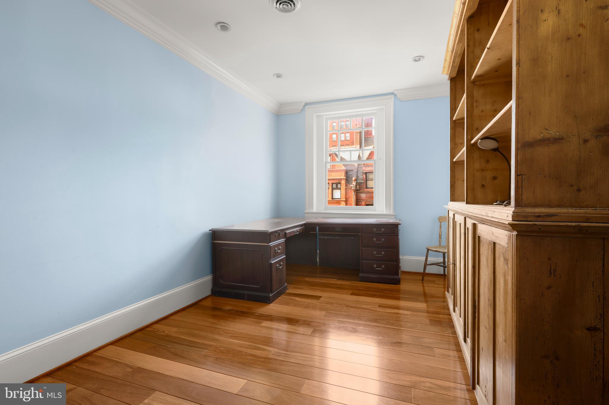 1007 North Calvert Street Baltimore, MD 21202 - Photo 39 of 43 a view of an empty room with wooden floor and a window