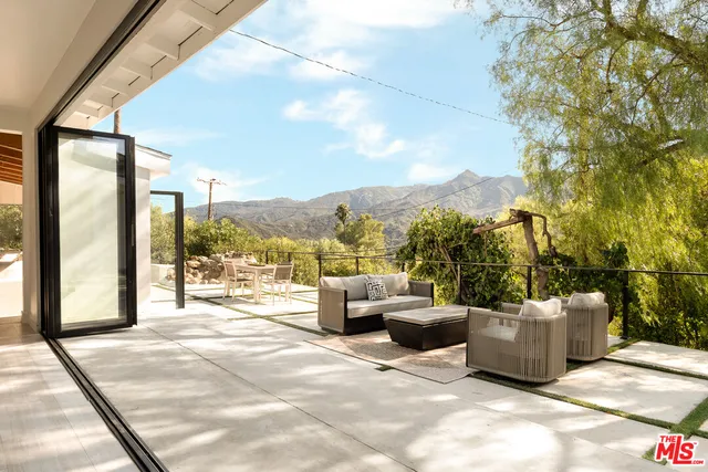 a view of a patio with couches and potted plants