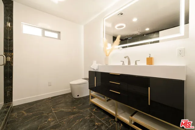 a bathroom with a sink and mirror