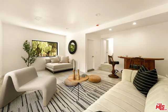 a living room with furniture and a lamp