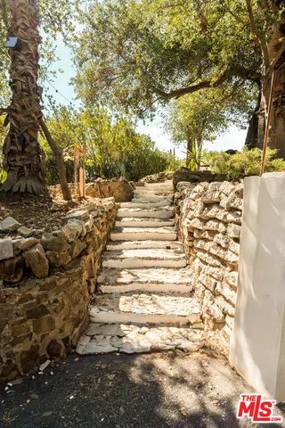 a backyard of a house with table and chairs