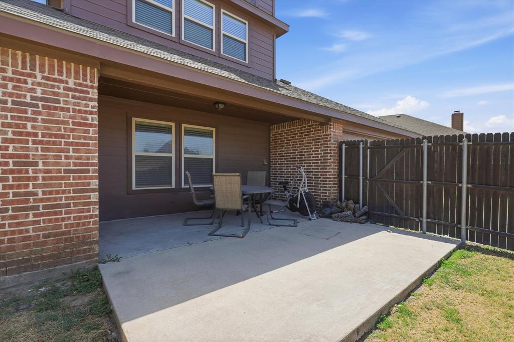 115 Blue Quail Road Red Oak, TX 75154 - Photo 25 of 35 Covered concrete patio with brick and siding exterior and fenced perimeter