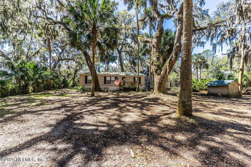a view of outdoor space with deck and trees