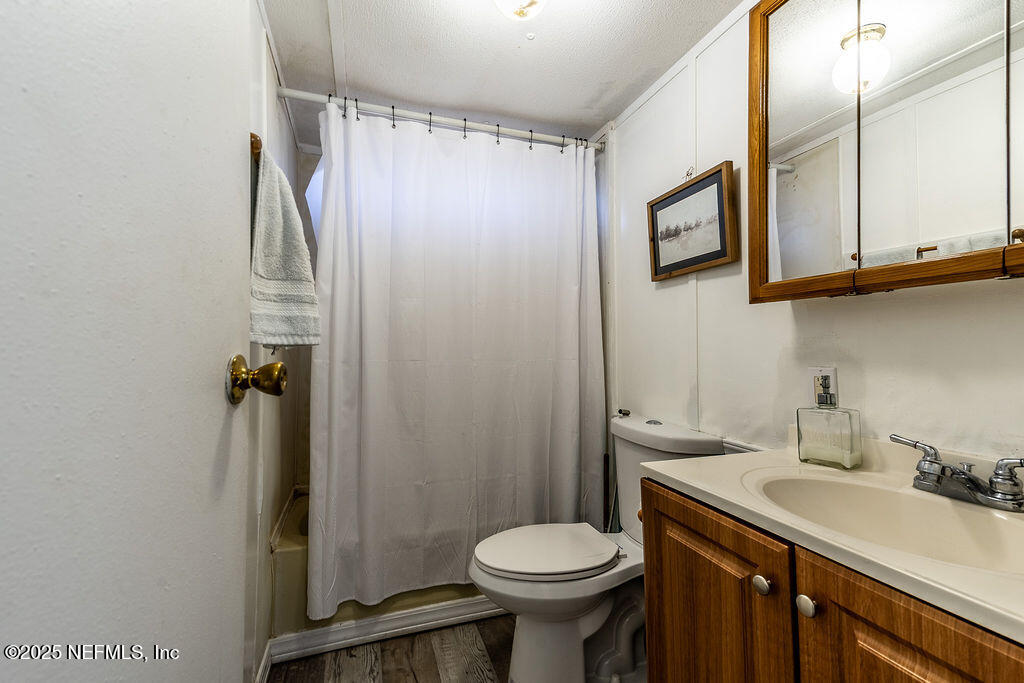 19040 Waterville Road Jacksonville, FL 32226 - Photo 19 of 28 a bathroom with a sink a toilet and shower