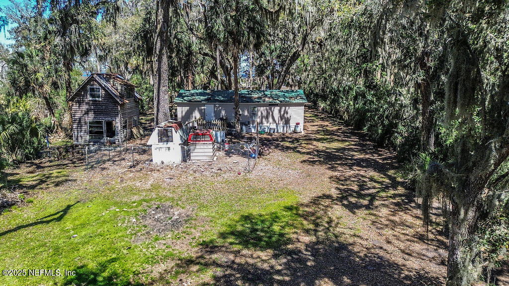 19040 Waterville Road Jacksonville, FL 32226 - Photo 20 of 28 a view of a patio with table and chairs and potted plants