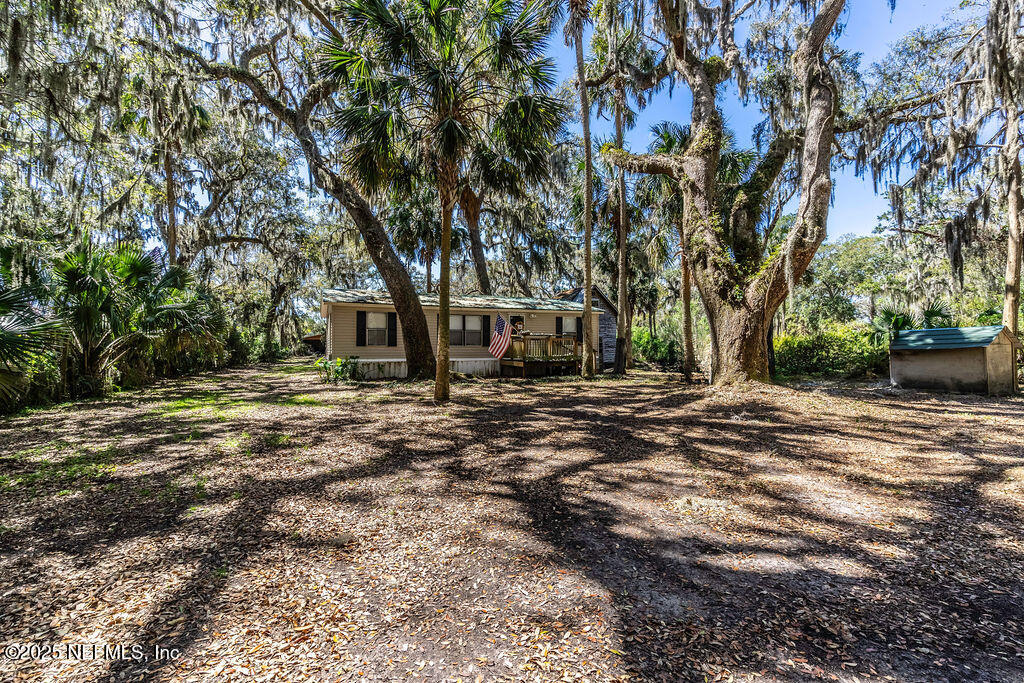 19040 Waterville Road Jacksonville, FL 32226 - Photo 4 of 28 a view of outdoor space with deck and tree