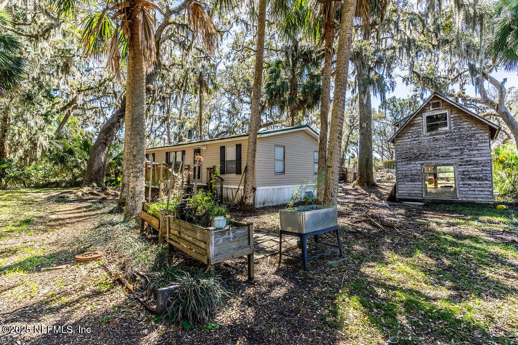 19040 Waterville Road Jacksonville, FL 32226 - Photo 6 of 28 a view of a house with backyard and sitting area