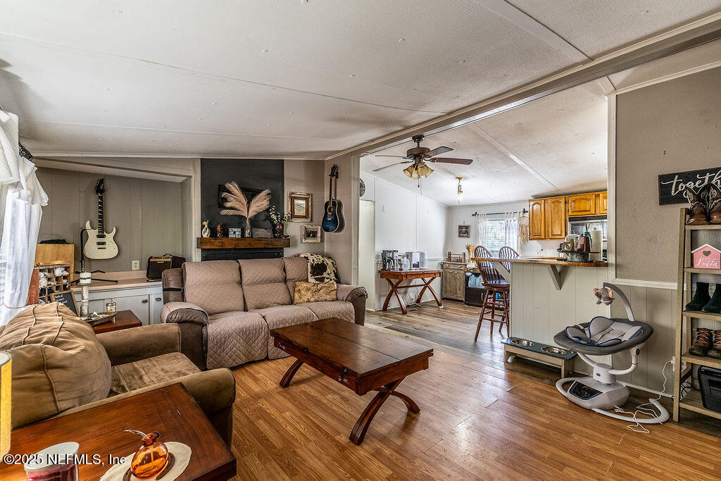 19040 Waterville Road Jacksonville, FL 32226 - Photo 8 of 28 a living room with furniture a wooden floor and a sink