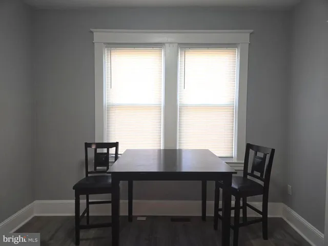 a view of a workspace with a table and chairs in it
