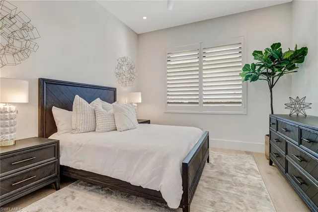 a bedroom with a bed and a potted plant