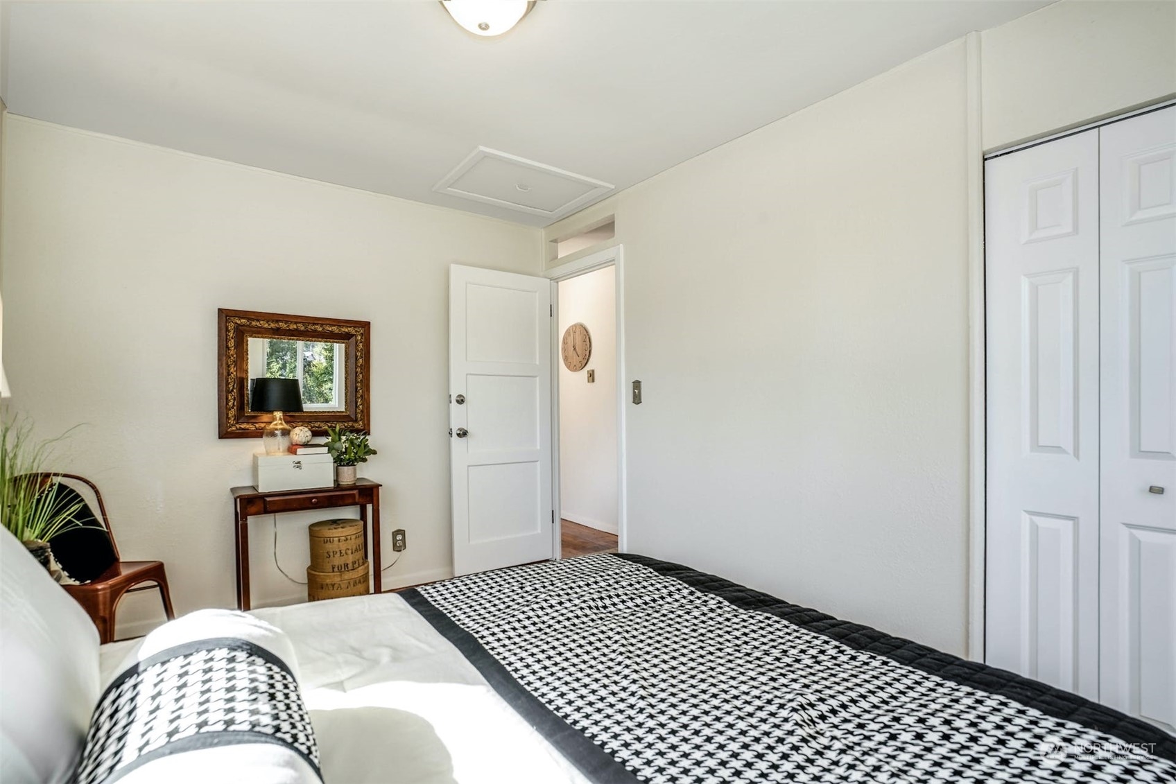 14520 Renton Issaquah Road Southeast Renton, WA 98059 - Photo 11 of 34 a bedroom with a bed and wooden floor