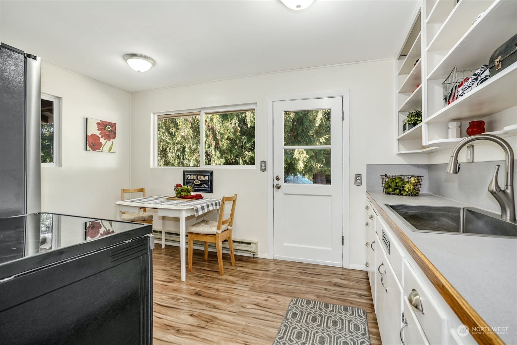 14520 Renton Issaquah Road Southeast Renton, WA 98059 - Photo 7 of 34 a kitchen with a stove a sink a dining table and chairs