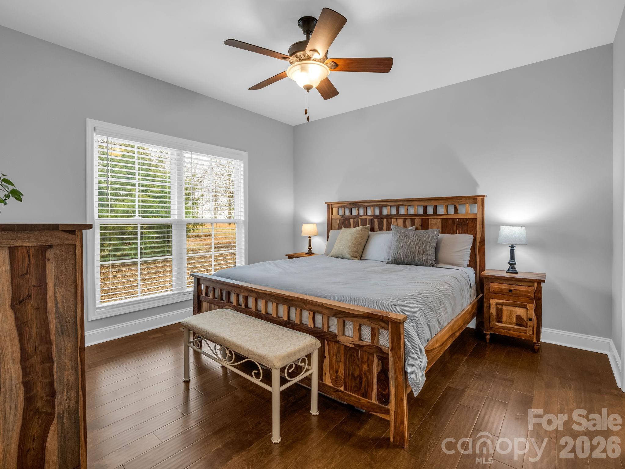 631 Mountain Parkway Mill Spring, NC 28756 - Photo 17 of 43 a bedroom with a bed and a chandelier