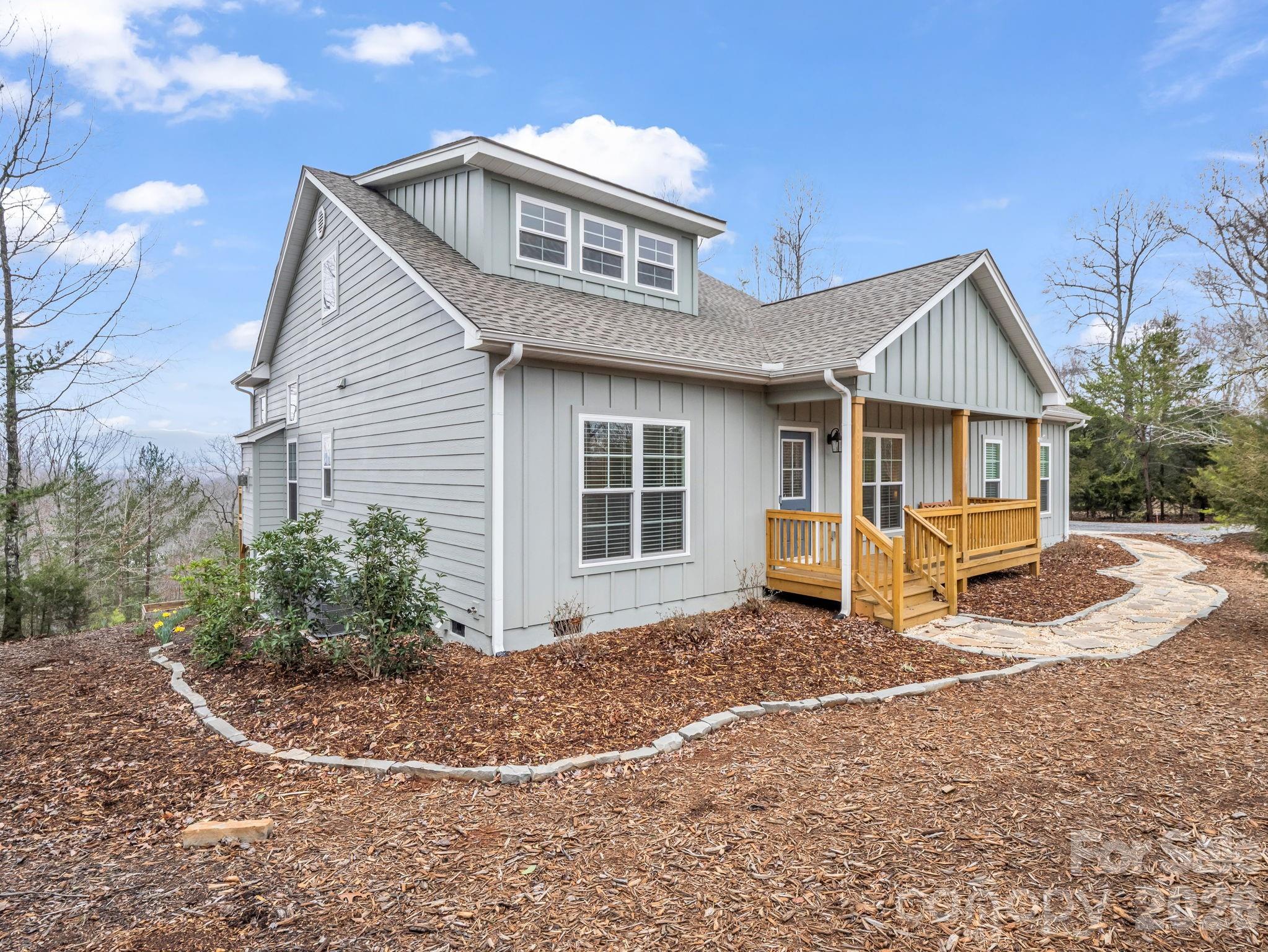 631 Mountain Parkway Mill Spring, NC 28756 - Photo 2 of 43 a front view of a house with garden