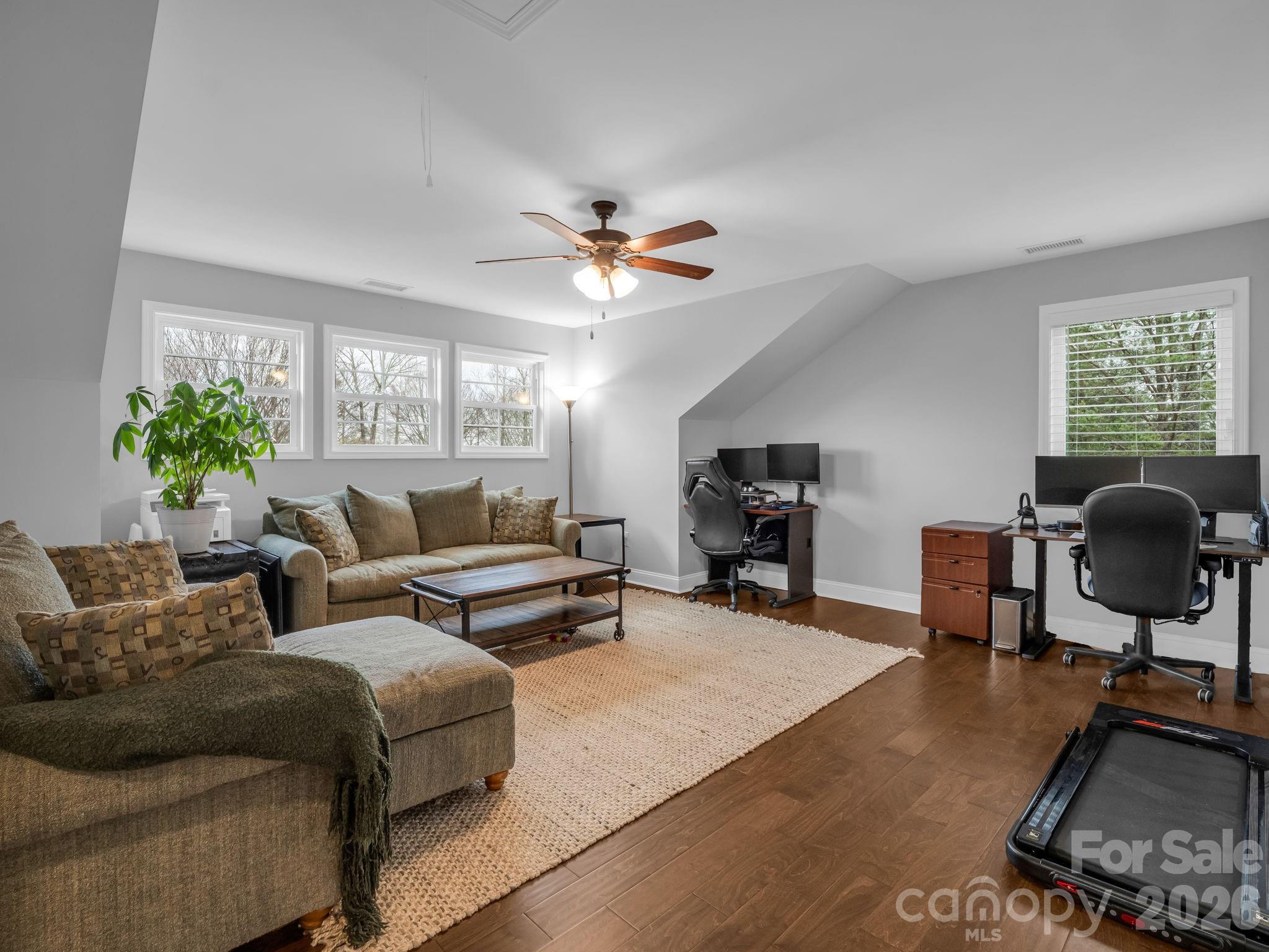 631 Mountain Parkway Mill Spring, NC 28756 - Photo 23 of 43 a living room with furniture ceiling fan and a window
