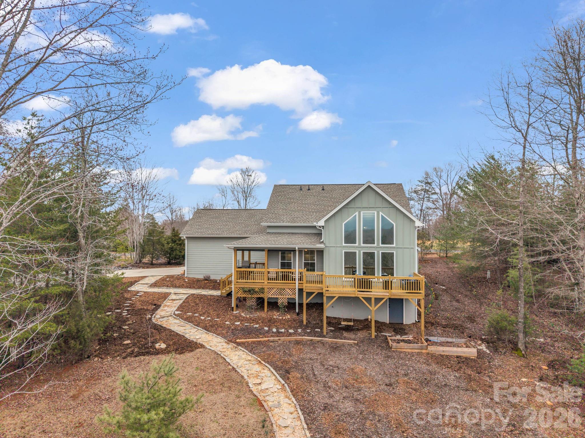 631 Mountain Parkway Mill Spring, NC 28756 - Photo 4 of 43 a view of a house with backyard porch and sitting area
