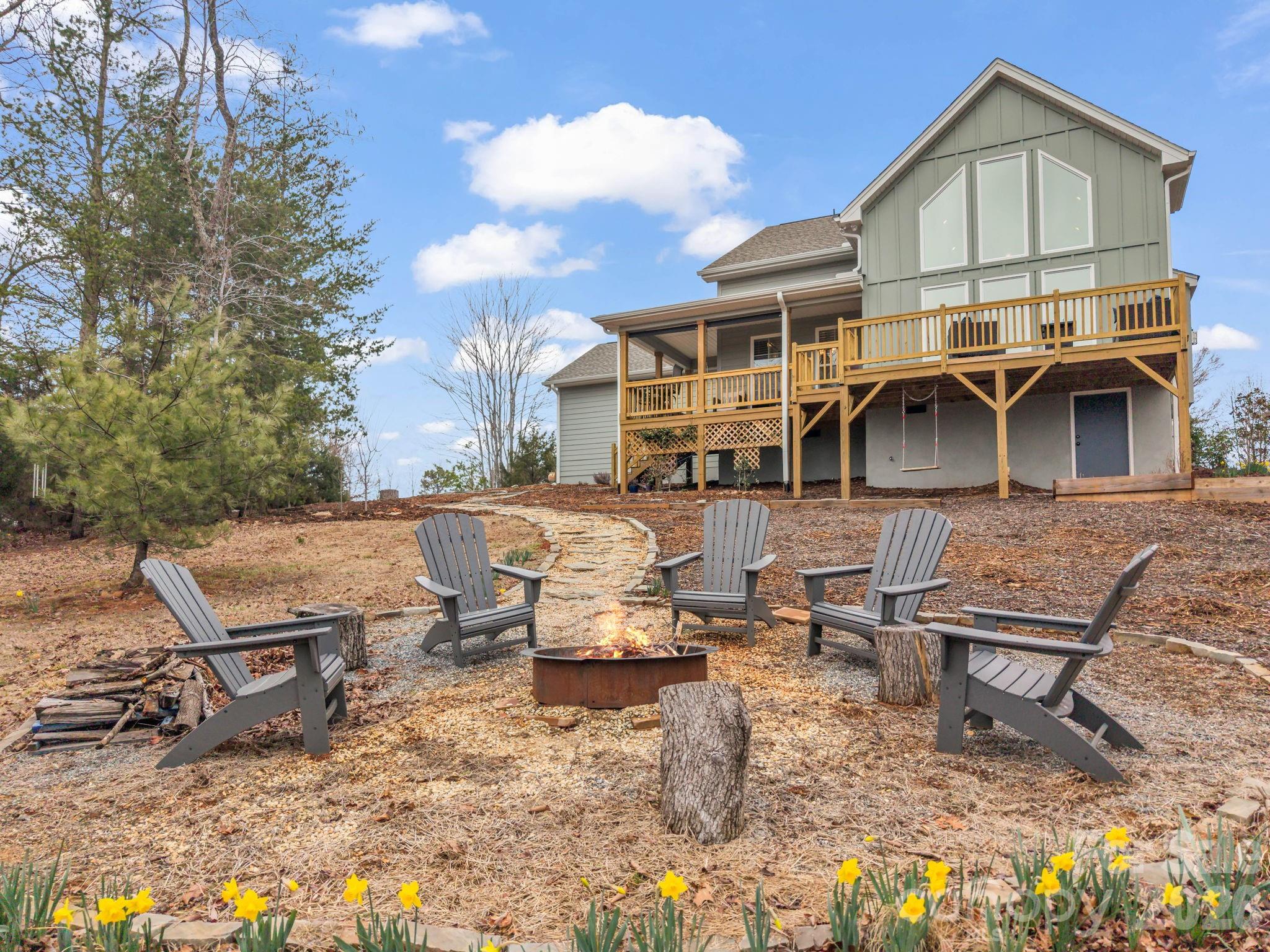 631 Mountain Parkway Mill Spring, NC 28756 - Photo 5 of 43 a picture of table and chairs in front of house