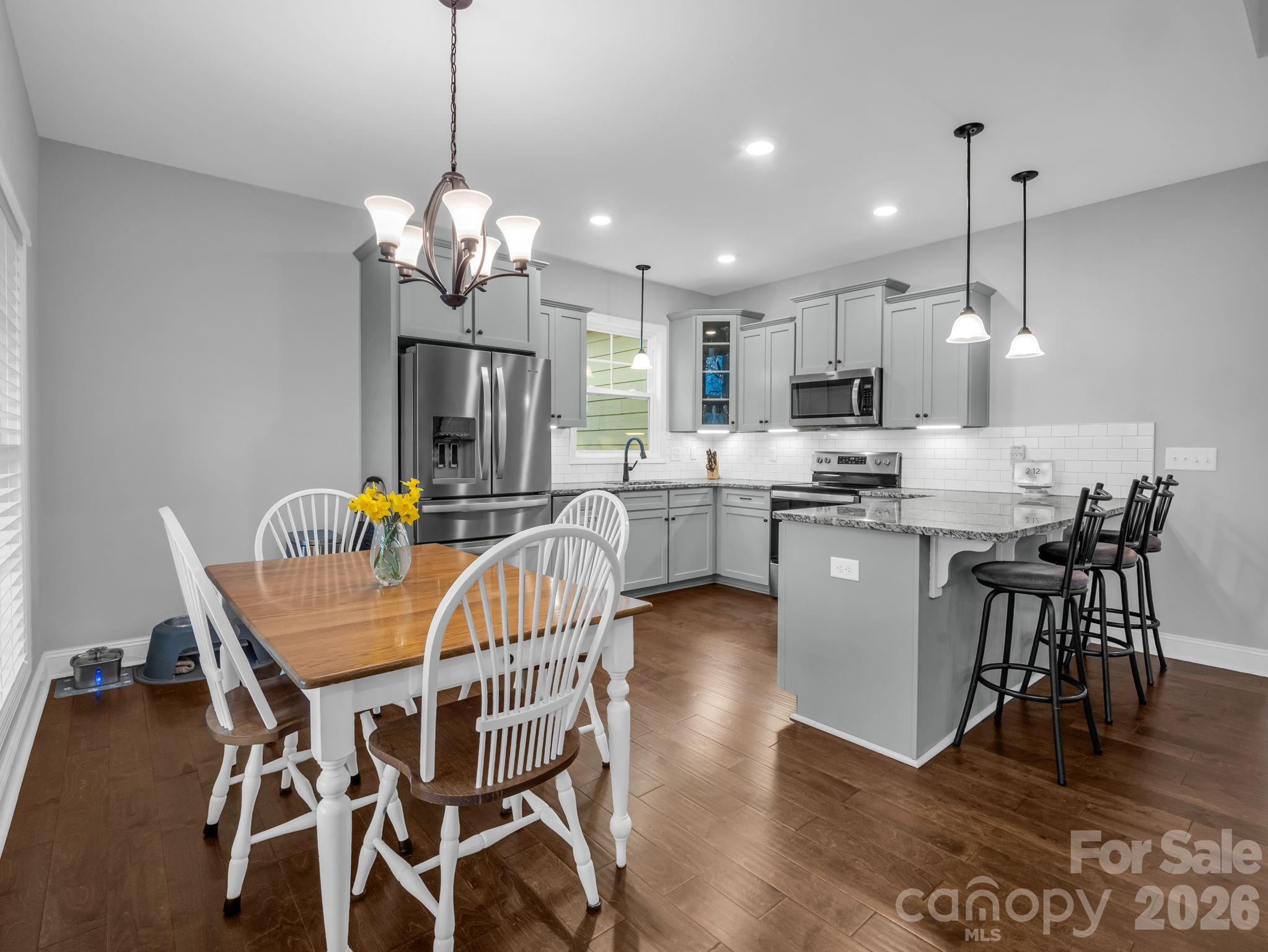 631 Mountain Parkway Mill Spring, NC 28756 - Photo 9 of 43 a view of a dining room with furniture wooden floor and chandelier