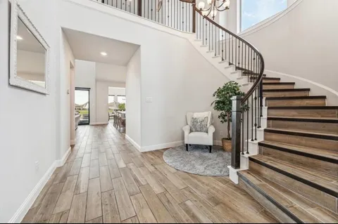 a view of entryway and hall with wooden floor