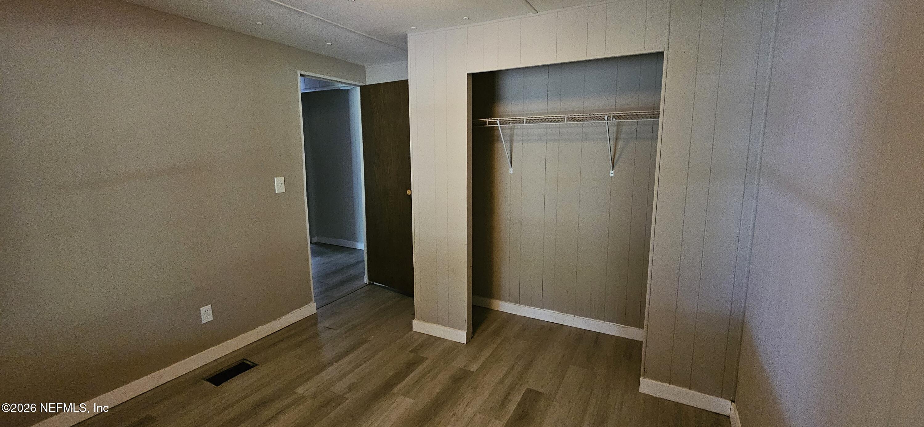 5363 Kilcrease Road Jacksonville, FL 32234 - Photo 12 of 29 a view of an empty room with wooden floor and closet