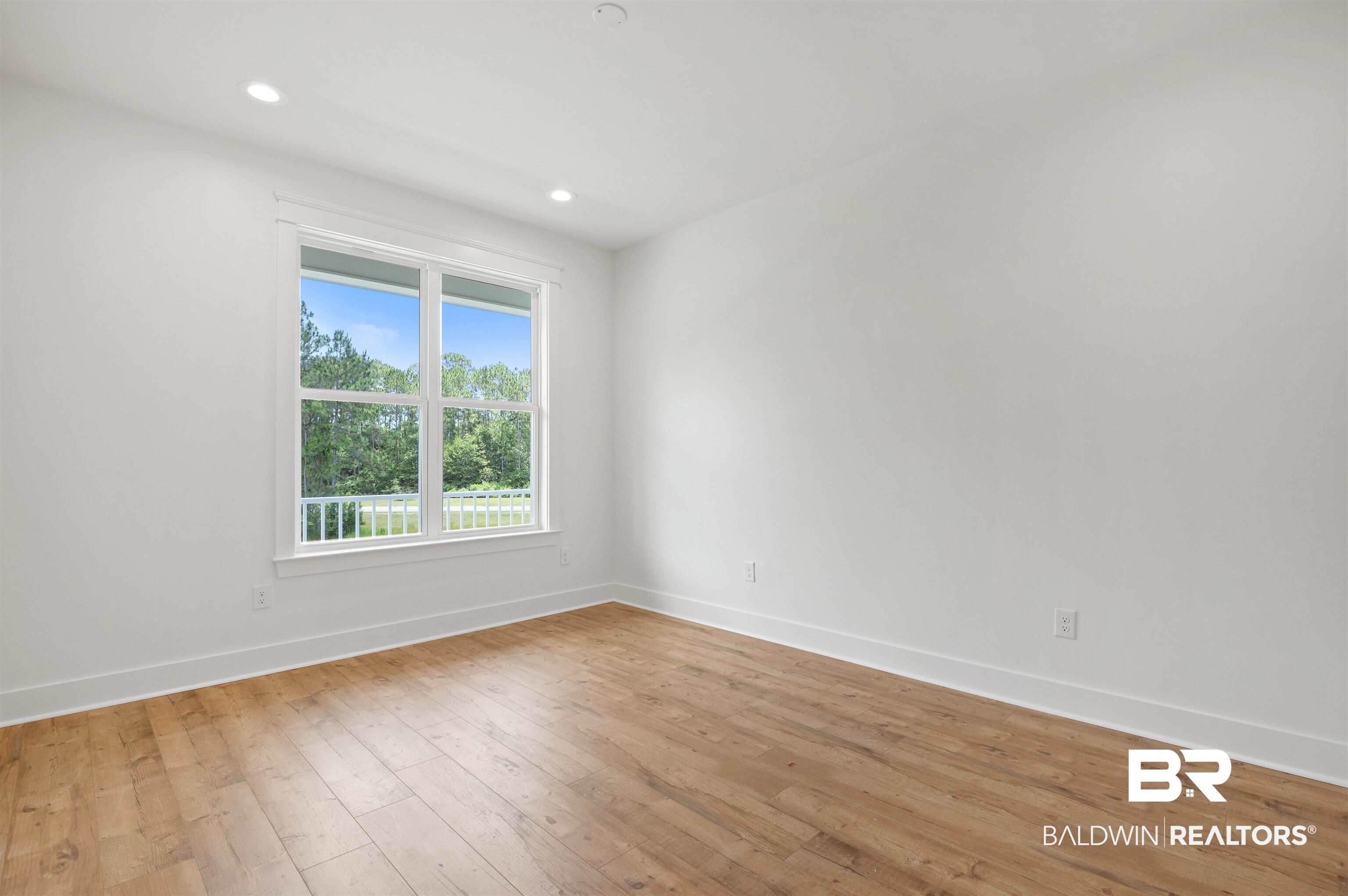 657 Island Way Gulf Shores, AL 36542 - Photo 32 of 59 Empty room with baseboards, light wood-style flooring, and recessed lighting