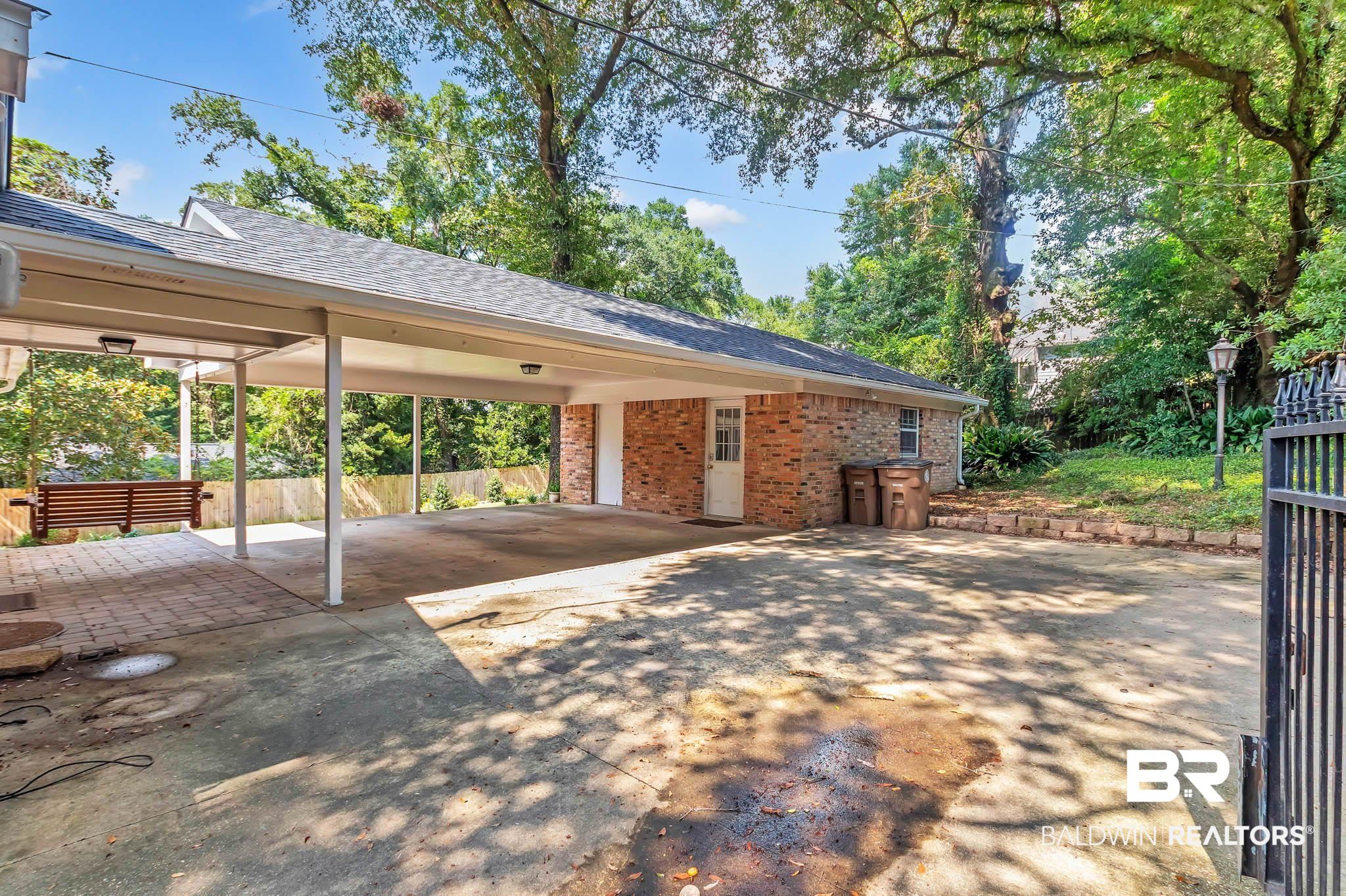 309 West Brandy Run Road Mobile, AL 36608 - Photo 81 of 100 View of parking / parking lot with concrete driveway and an attached carport