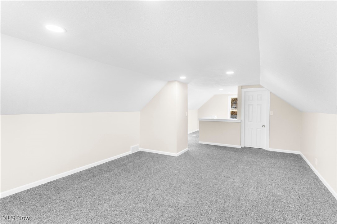 3441 Bell Wick Road Hubbard, OH 44425 - Photo 13 of 22 Additional living space with carpet and vaulted ceiling