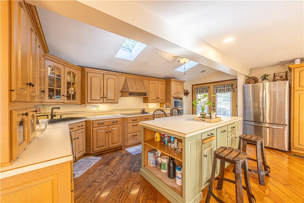 130 Alpine Smock, PA 15480 - Photo 12 of 41 a kitchen with a stove a sink dishwasher and a refrigerator with wooden floor