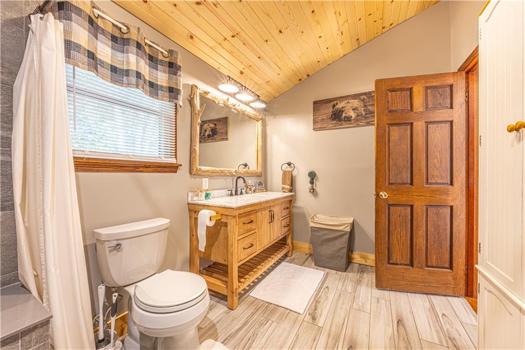 130 Alpine Smock, PA 15480 - Photo 19 of 41 a bathroom with a granite countertop toilet a sink a mirror a vanity and shower