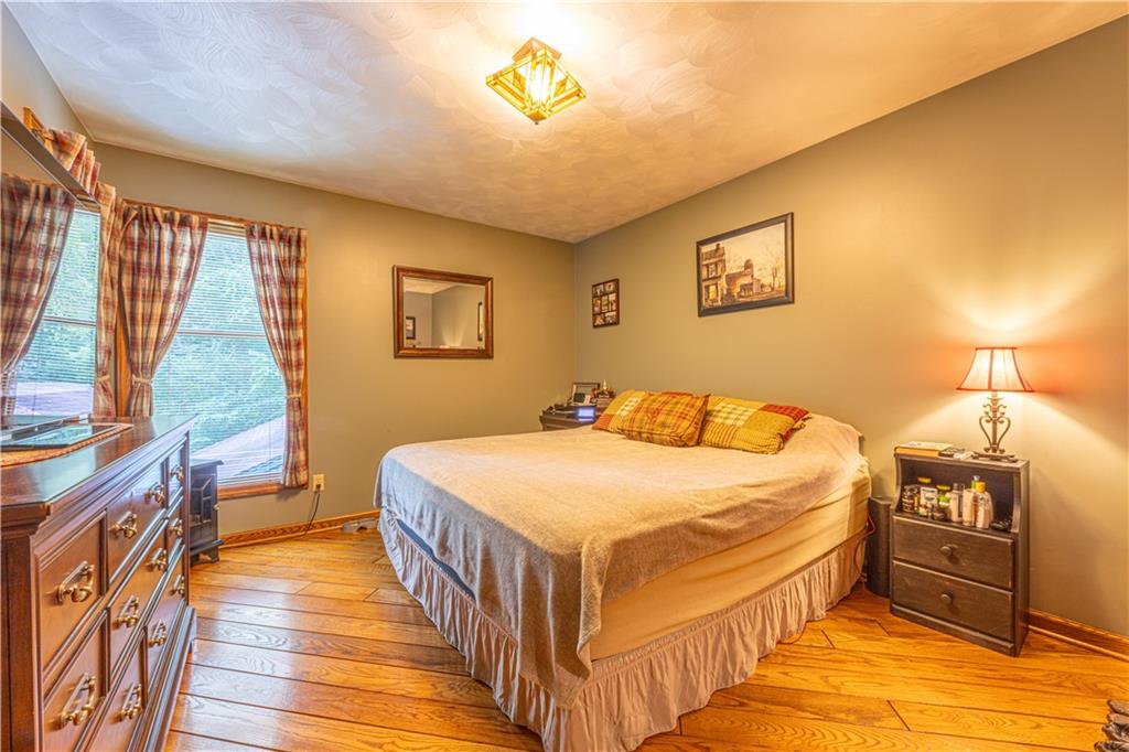 130 Alpine Smock, PA 15480 - Photo 22 of 41 a bedroom with a bed and a chandelier