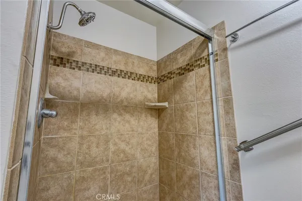 a bathroom with a glass shower door