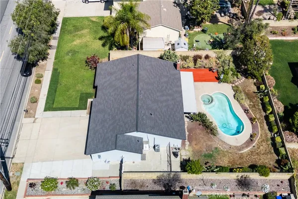 an aerial view of a house with a yard and lake view