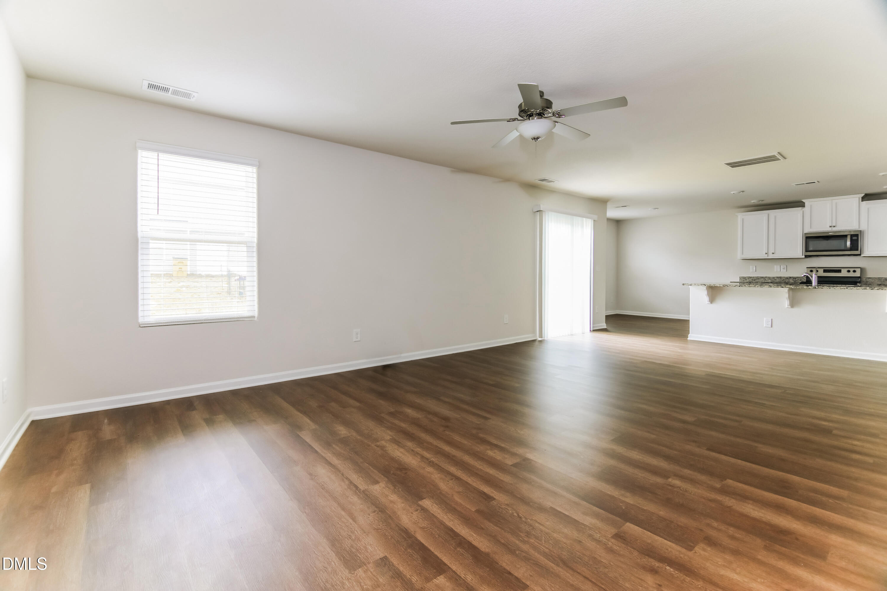 336 Gourd Street Zebulon, NC 27597 - Photo 4 of 17 a view of empty room with wooden floor and window