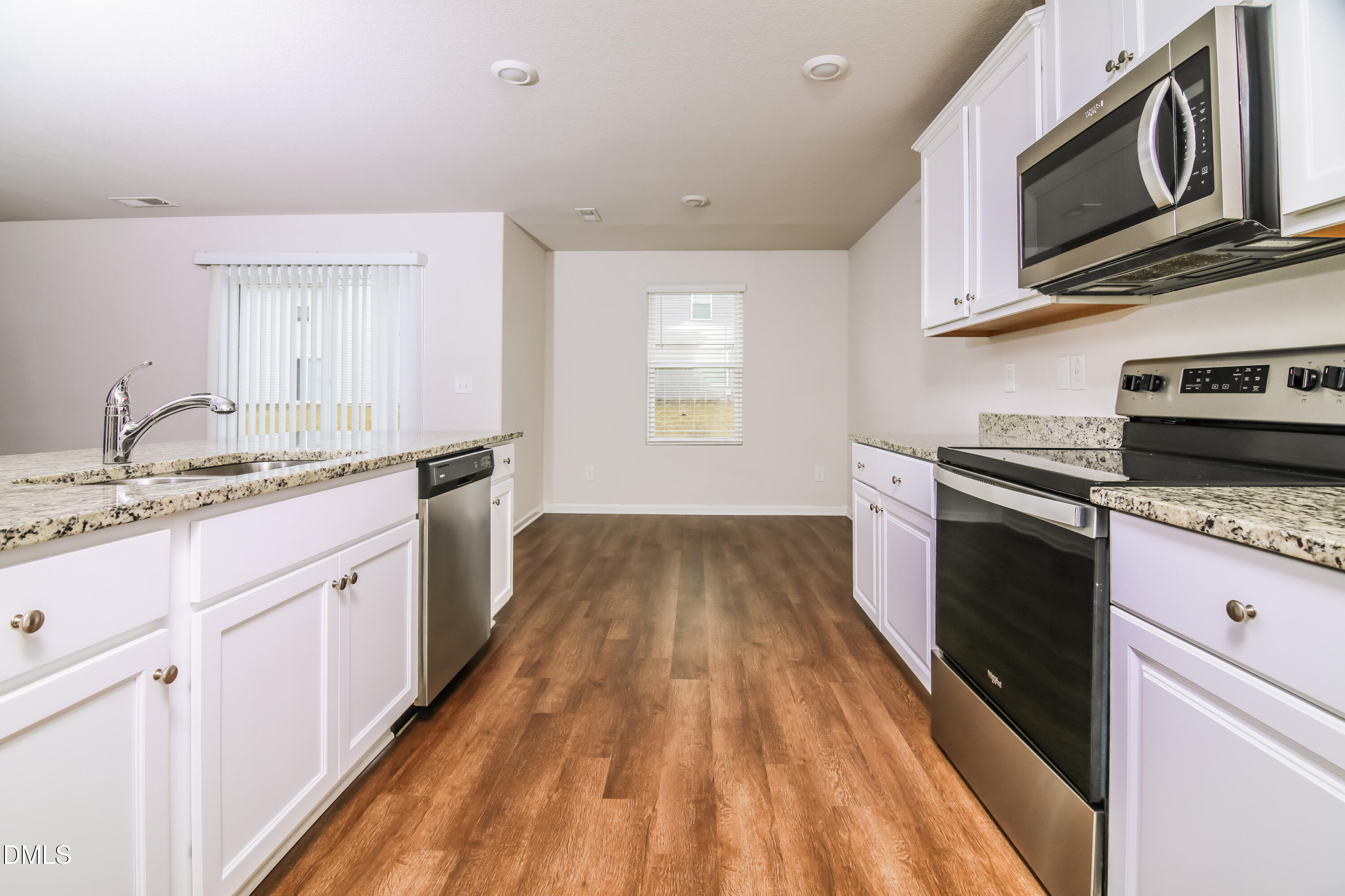 336 Gourd Street Zebulon, NC 27597 - Photo 7 of 17 a kitchen with stainless steel appliances granite countertop a stove a sink and a microwave