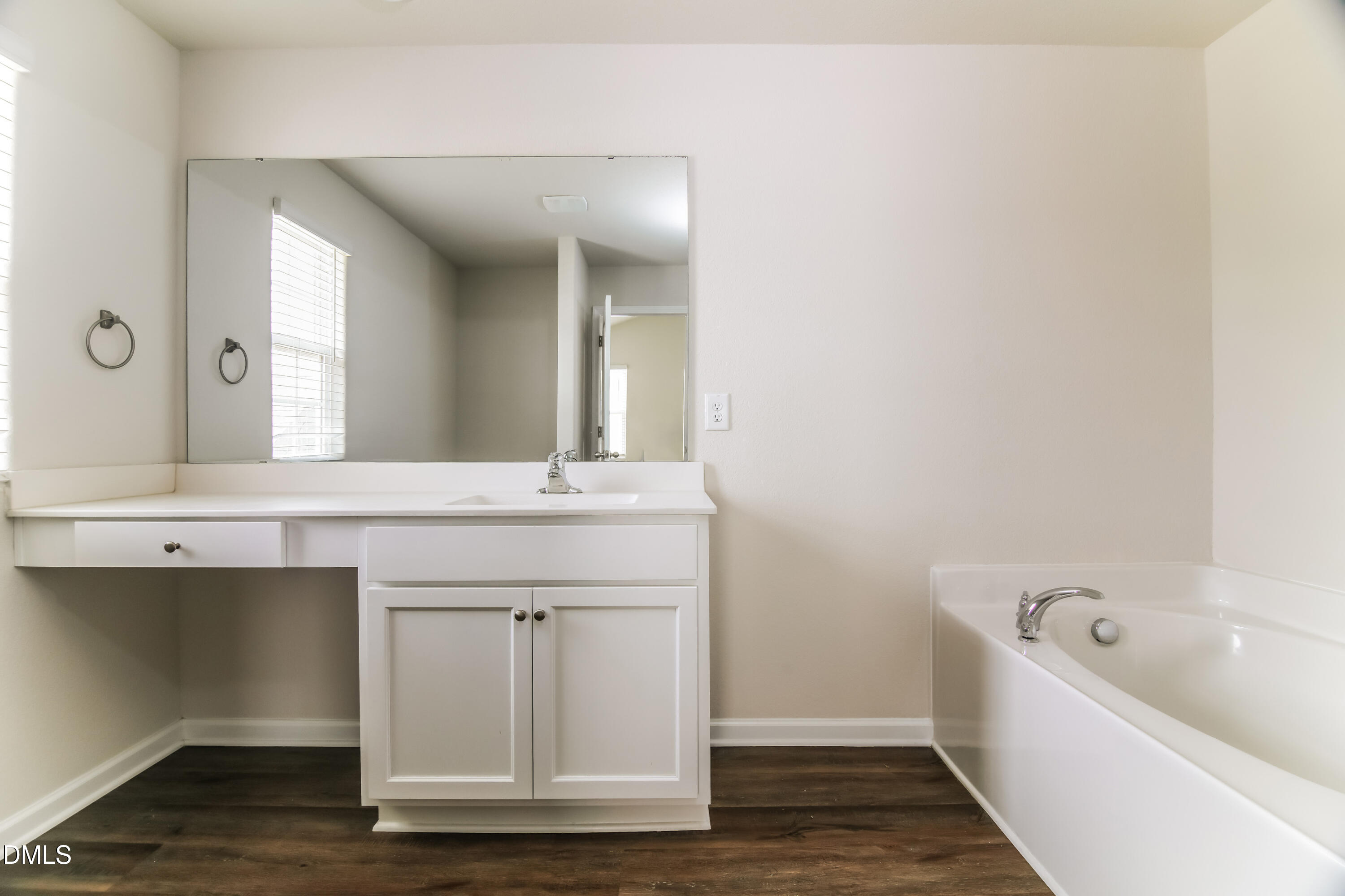 336 Gourd Street Zebulon, NC 27597 - Photo 10 of 17 a bathroom with a granite countertop sink a mirror and bathtub