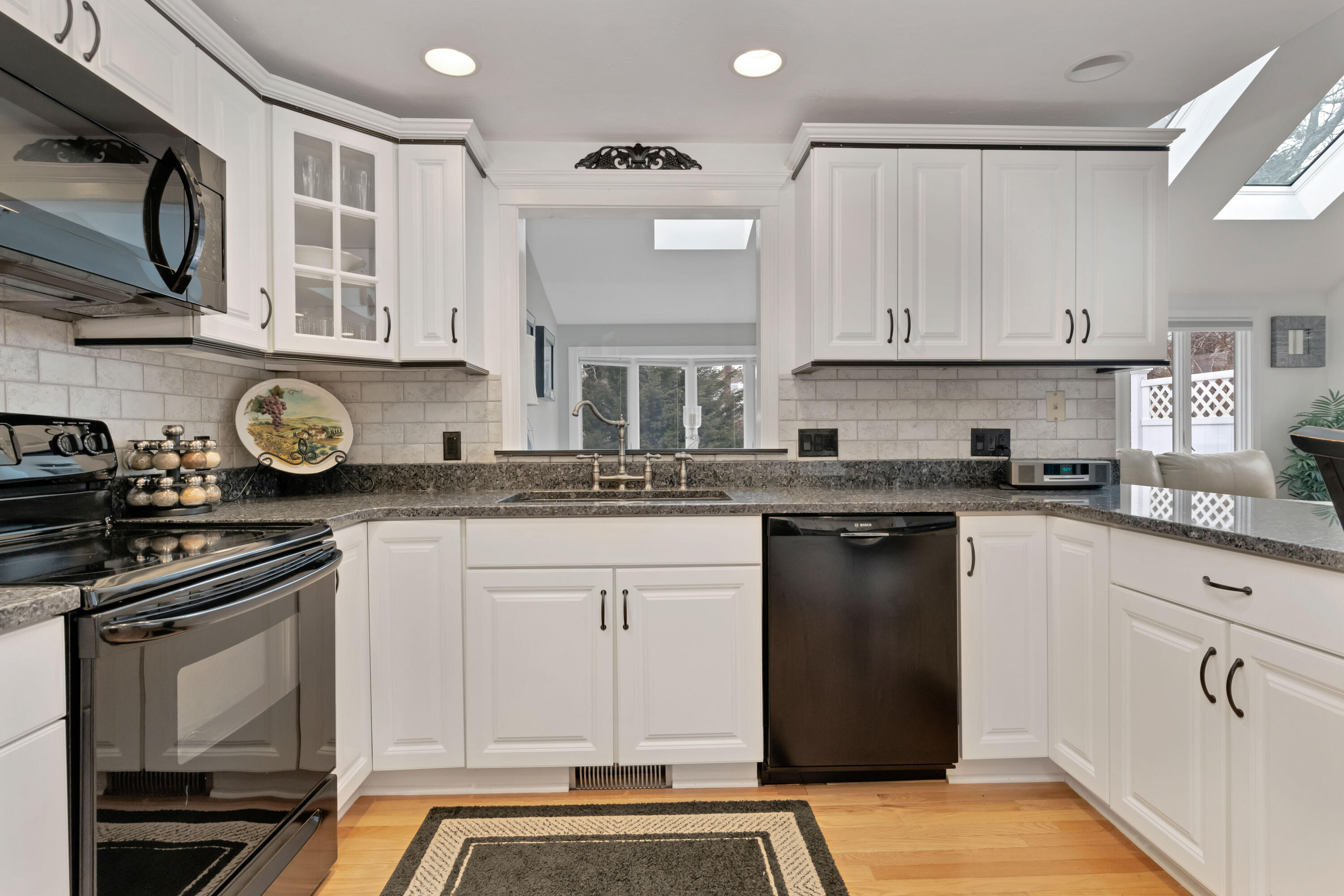 48 Square Rigger Lane Hyannis, MA 02601 - Photo 16 of 36 a kitchen with stainless steel appliances granite countertop a stove a sink and a microwave