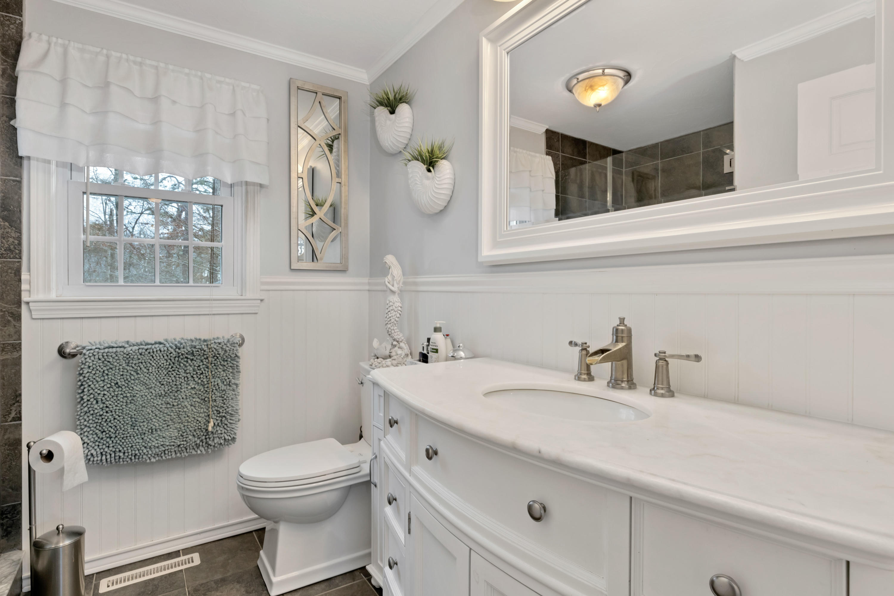 48 Square Rigger Lane Hyannis, MA 02601 - Photo 21 of 36 a bathroom with a sink a toilet and a mirror