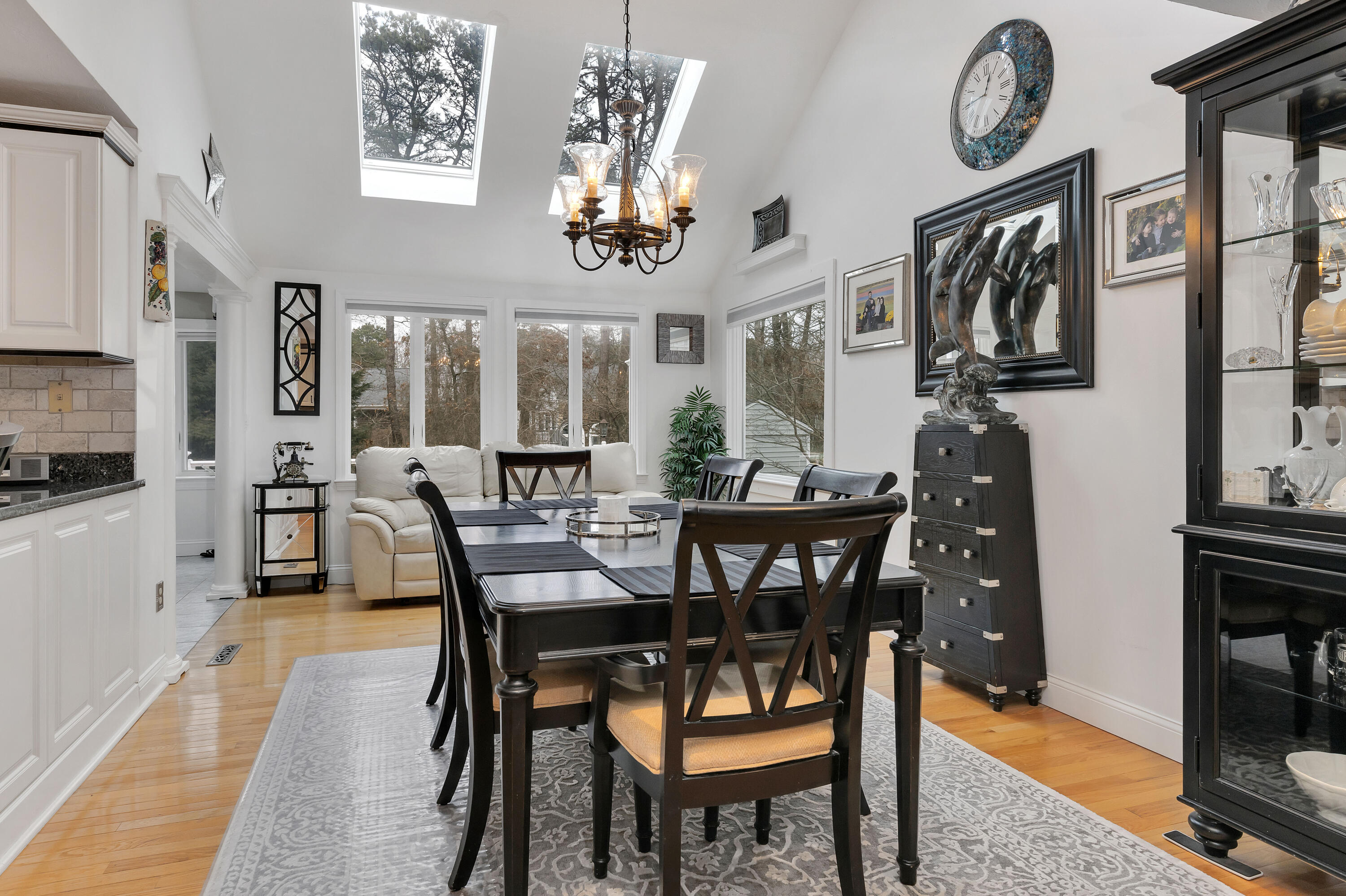 48 Square Rigger Lane Hyannis, MA 02601 - Photo 7 of 36 a view of a dining room with furniture a chandelier and wooden floor
