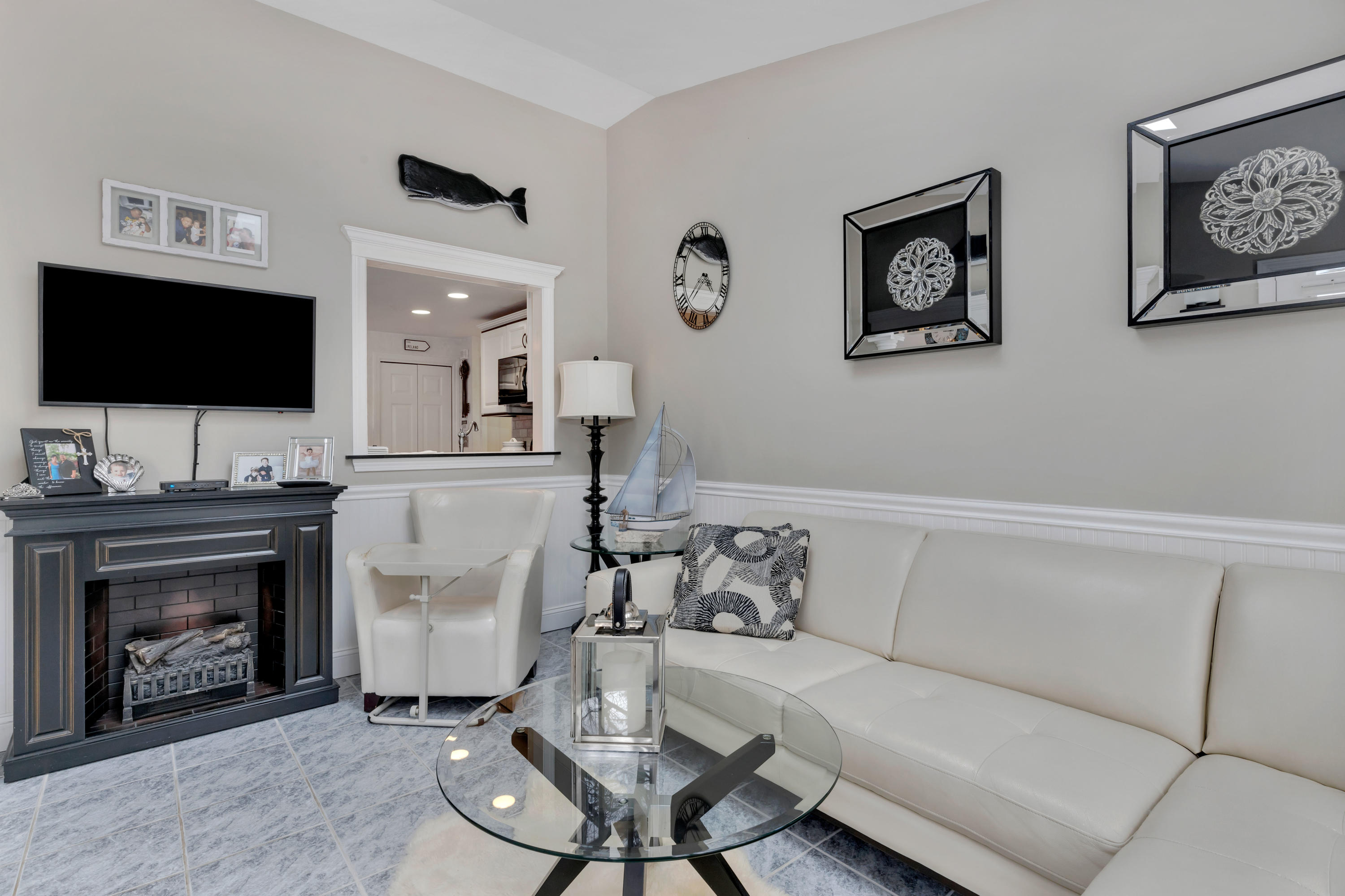 48 Square Rigger Lane Hyannis, MA 02601 - Photo 9 of 36 a living room with furniture a flat screen tv and a fireplace