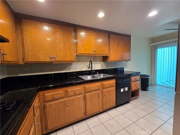 a kitchen with granite countertop sink and cabinets