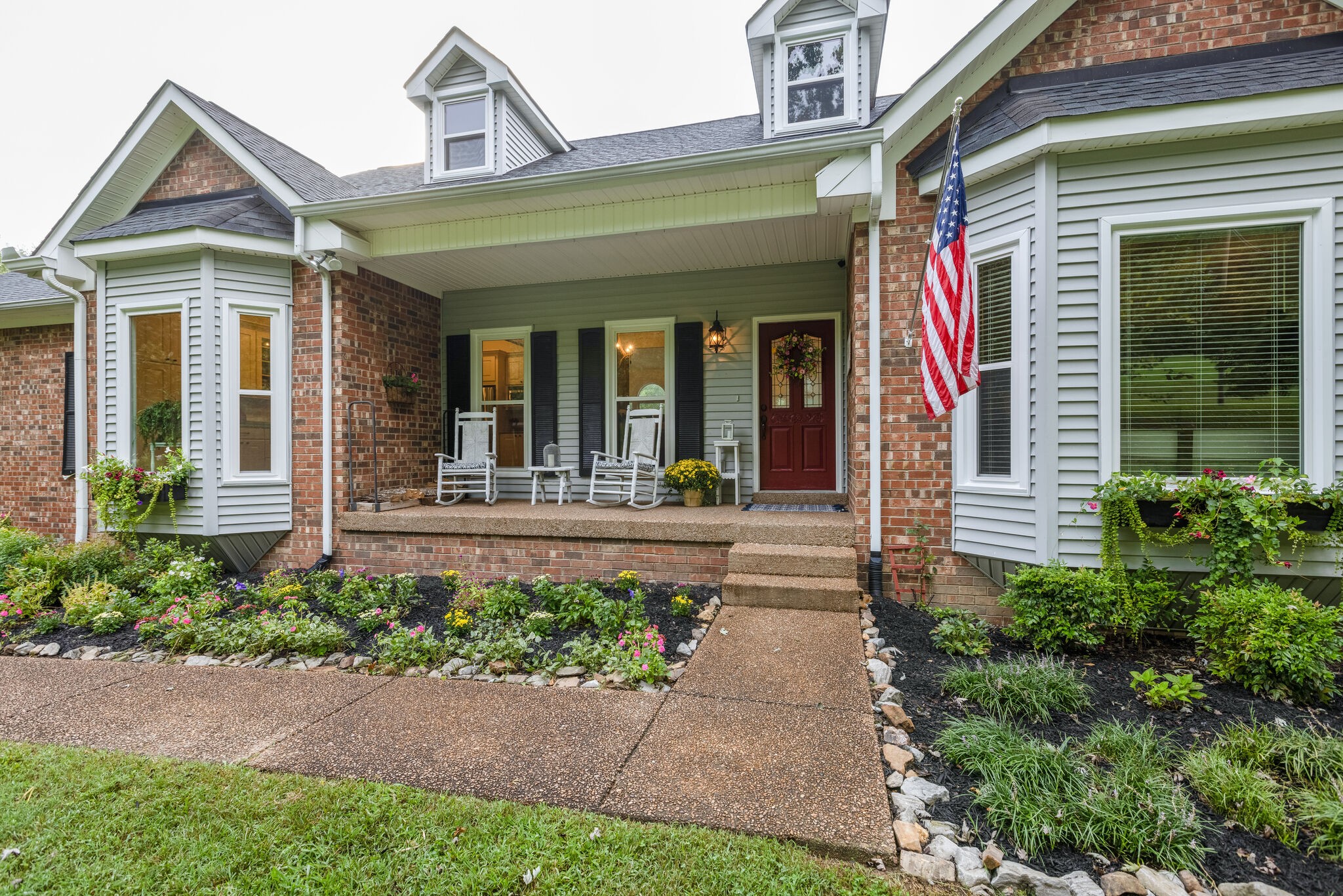 763 High Point Ridge Road Franklin, TN 37069 - Photo 3 of 46 a view of a house with potted plants and a bench