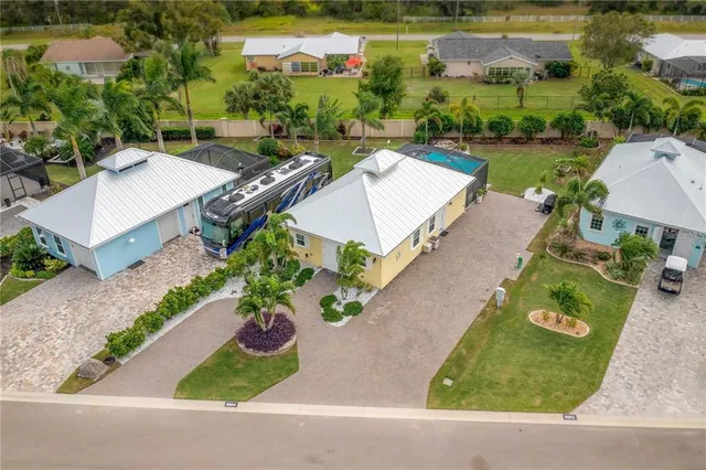an aerial view of a house with a yard and outdoor seating