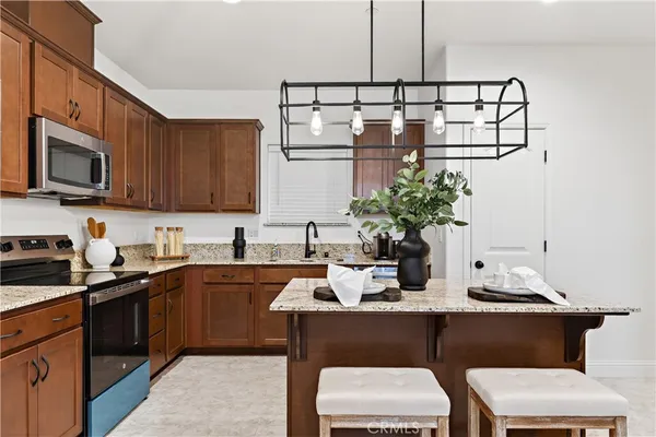 a kitchen with a sink cabinets and chair