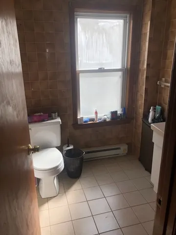 a bathroom with a toilet sink and window