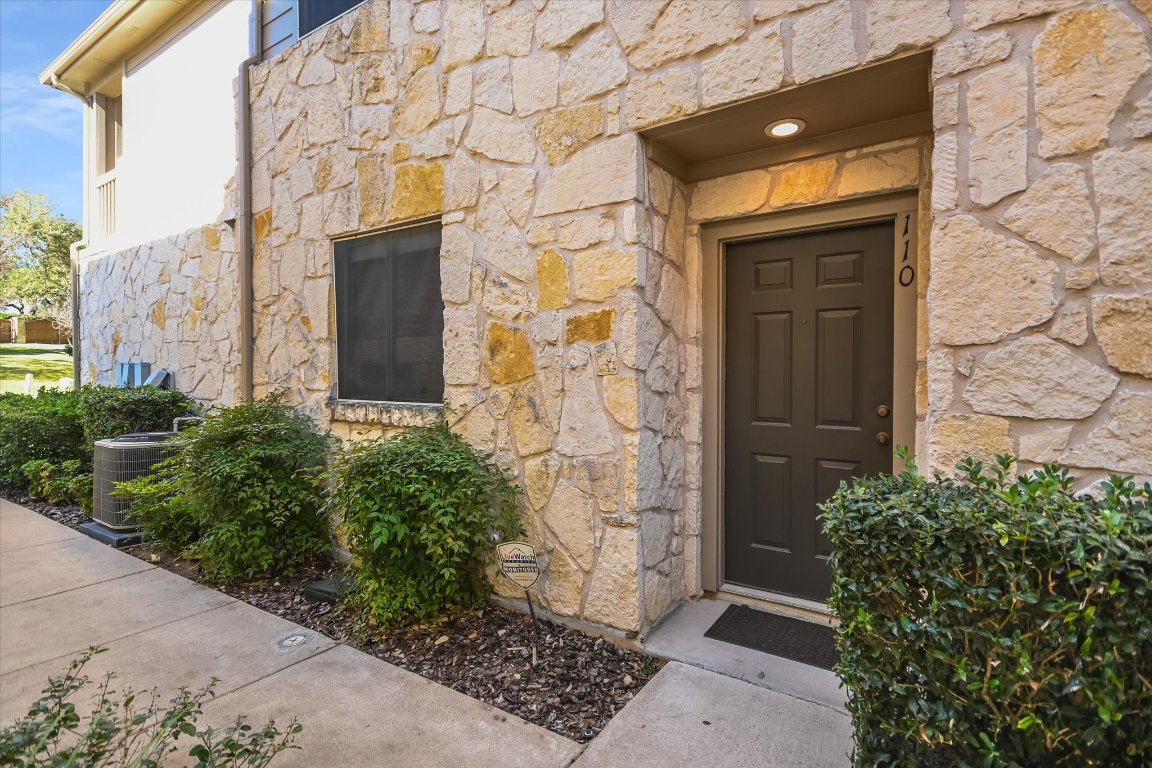 7501 Shadowridge Run, Unit 110 Austin, TX 78749 - Photo 2 of 20 The front entrance is tucked at the side of the building for added privacy.